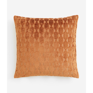 orange velvet pillow with a geometric pattern