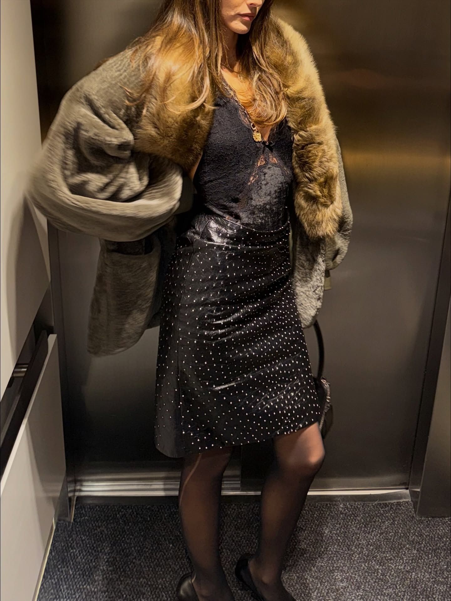 Vittoria Ceretti wearing a skirt outfit idea for 2026, including a fur-trim jacket with a lace camisole and animal-print skirt.