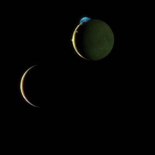 This is a composite image of Jupiter's volcanic moon Io and Europa taken during a March 2, 2007 flyby by NASA's New Horizons spacecraft. Here Io (top) steals the show with its beautiful display of volcanic activity. Three volcanic plumes are visible. Most conspicuous is the enormous 300-kilometer (190-mile) high plume from the Tvashtar volcano at the 11 o'clock position on Io's disk.