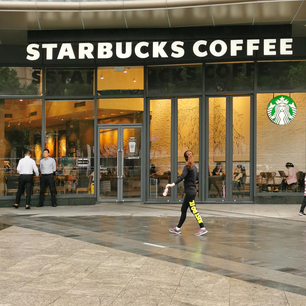 people in starbucks coffee and glass door
