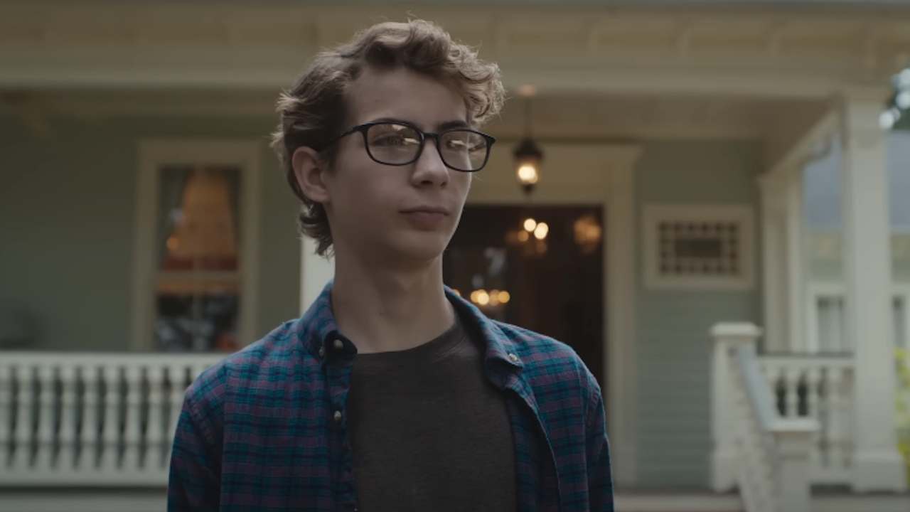 Jacob Tremblay with a house behind him as teen Chuck in The Life Of Chuck