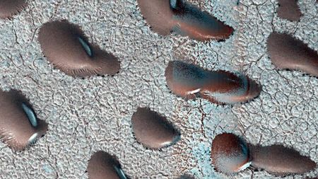 Frozen sand dunes sit locked in place in Mars' northern hemisphere, stuck until the spring thaw melts their icy shells