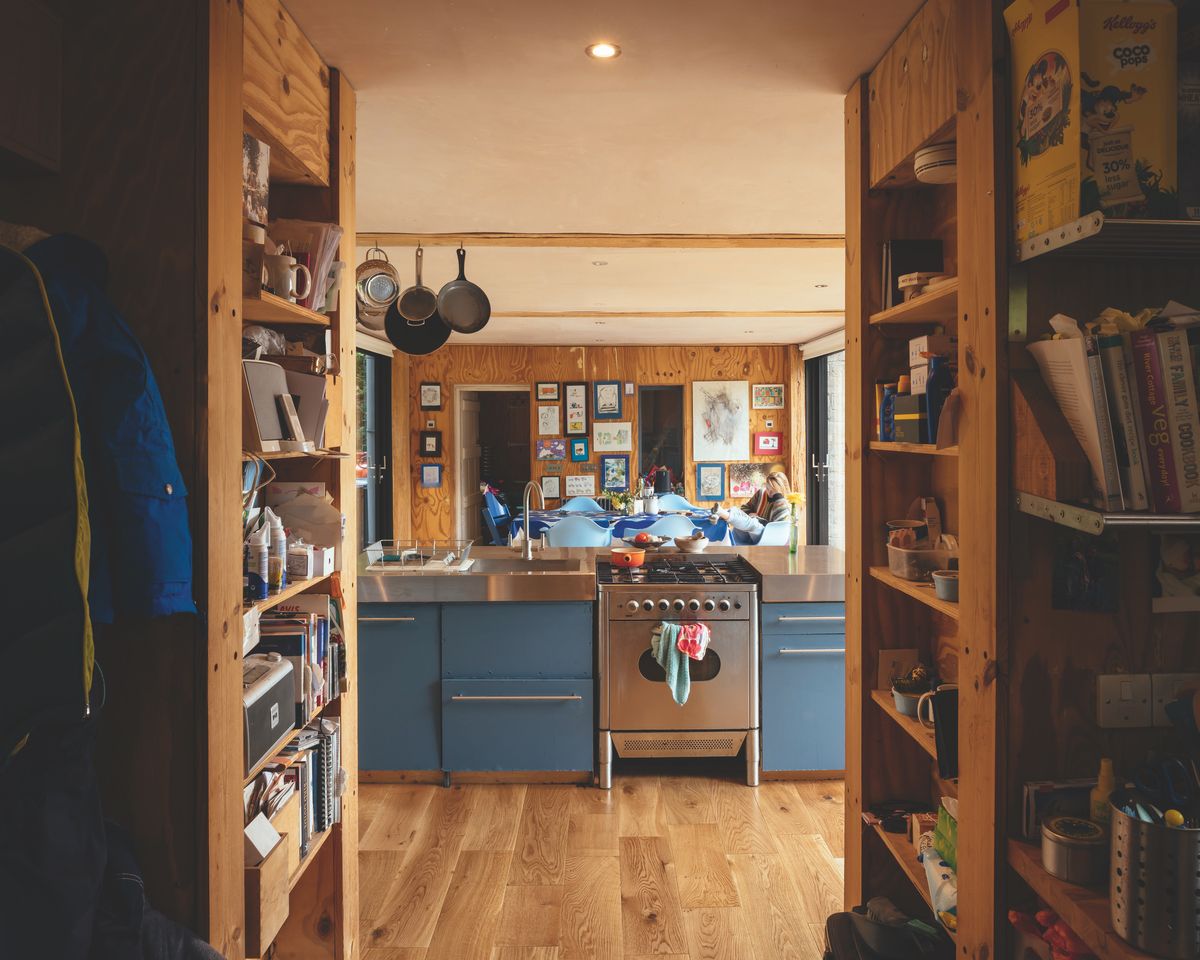 The budget Howdens kitchen has been upgraded with a new stainless steel worktop, while the utility behind the units (which houses various appliances) has been relocated to provide better storage and to reduce noise in the open-plan space.