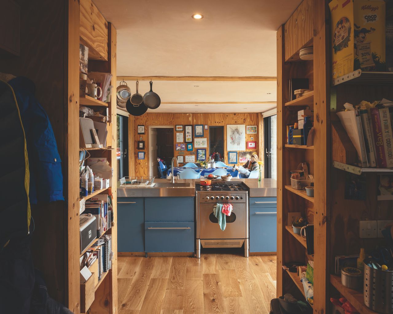 The budget Howdens kitchen has been upgraded with a new stainless steel worktop, while the utility behind the units (which houses various appliances) has been relocated to provide better storage and to reduce noise in the open-plan space.