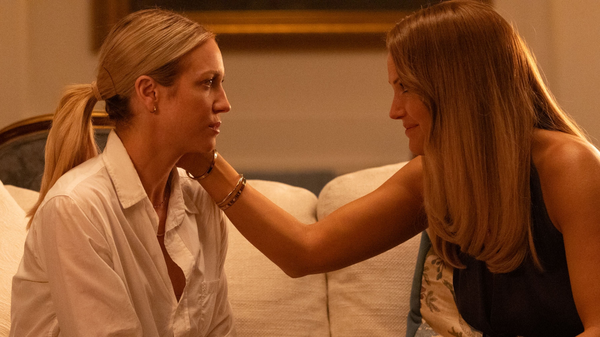 Margo strokes Sophie&#039;s cheek in The Hunting Wives