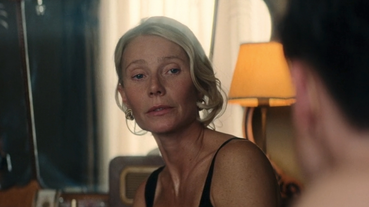 Gwyneth Paltrow in a black top looking towards the camera in Marty Supreme