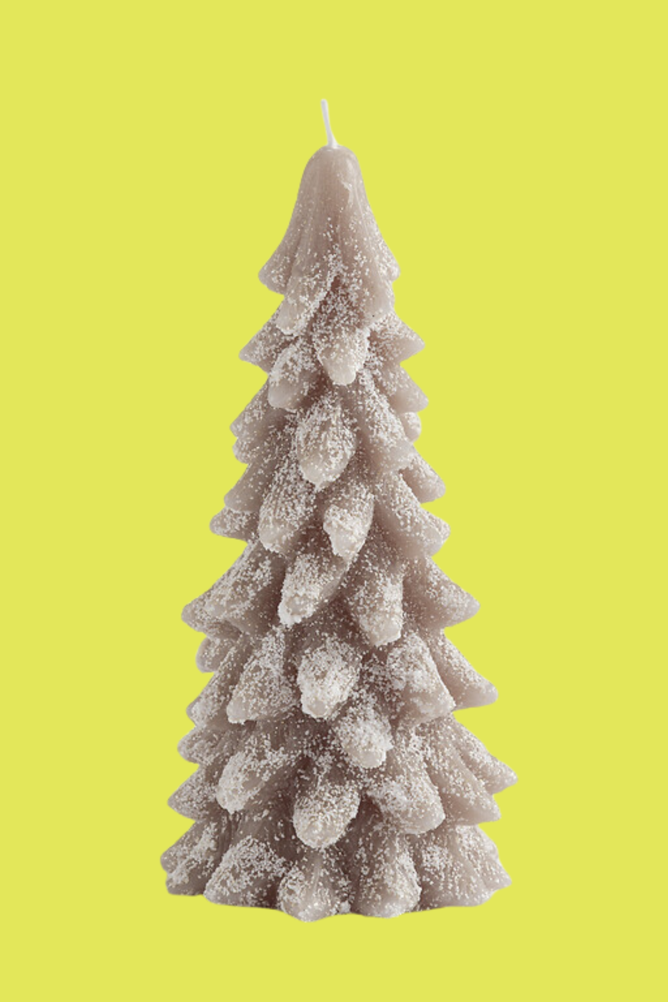 A brown Christmas tree-shaped candle with gold dusting
