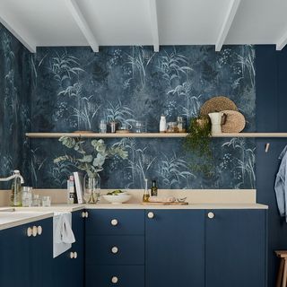 kitchen room with printed blue walls and kitchen cabinets