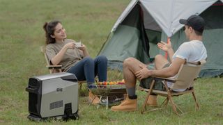 Couple talking at campsite with EcoFlow Wave