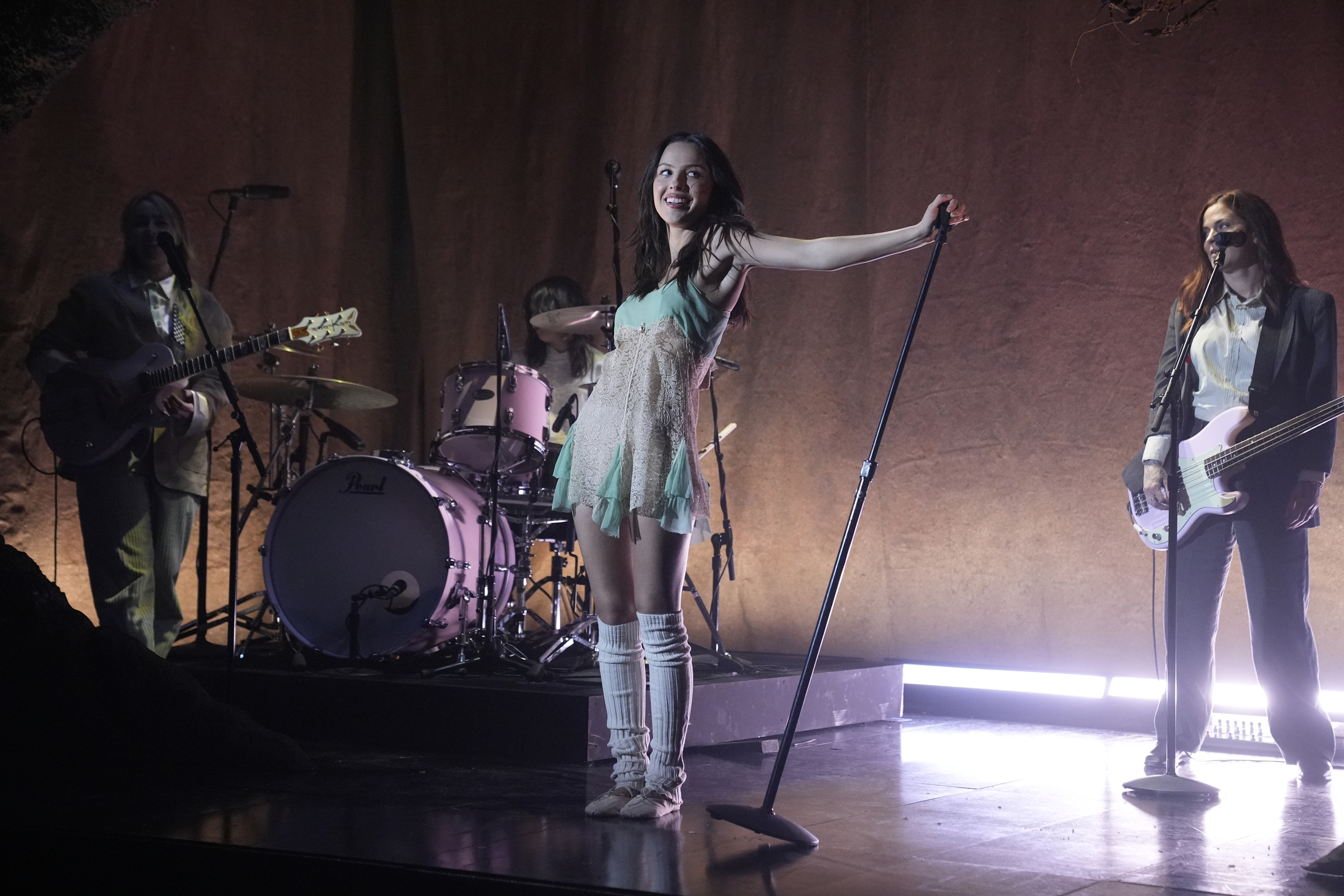 Olivia Rodrigo wearing a babydoll vintage dress on Saturday Night Live and performing Drop Dead