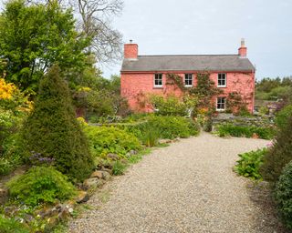 gravel driveway and pink cottage