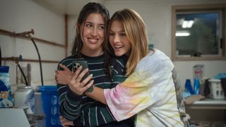 L-R: Devon (Sadie Sandler) being hugged by Celeste (Chloe East) in a scene from Netflix college comedy movie, "Roommates"