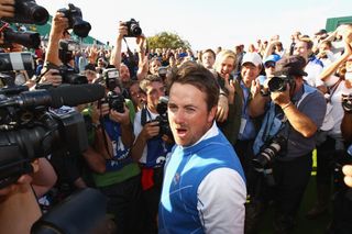 Graeme McDowell celebrates in front of a camera and fans at the 2010 Ryder Cup