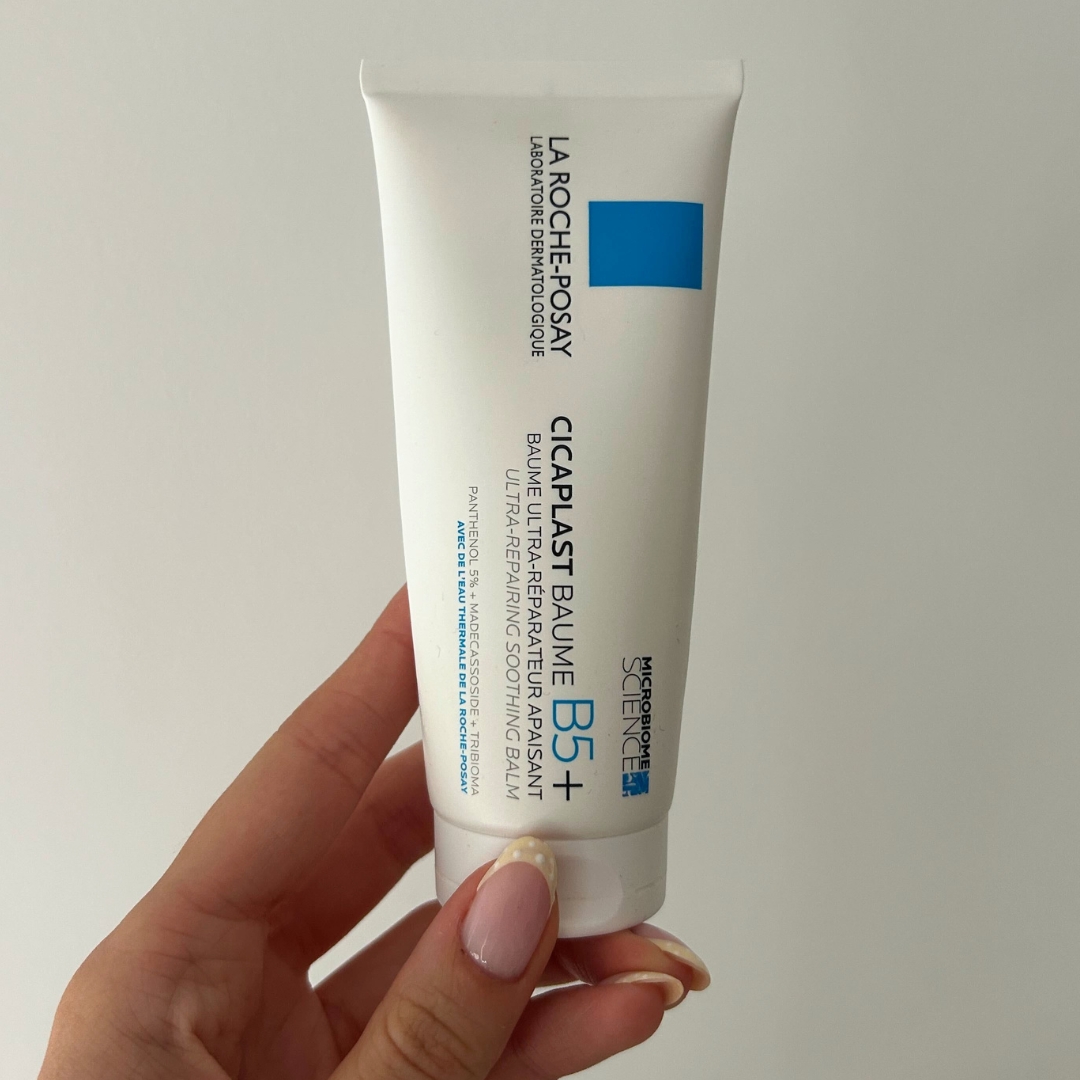 Hand holding a tube of La Roche-Posay Baume B5
