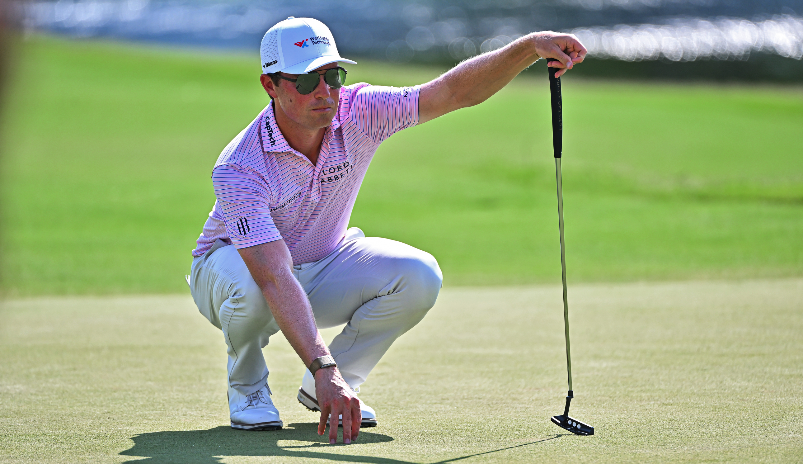 Ben Griffin lines up a putt with a putter in hand