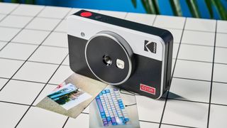 A black and gray Kodak Mini Shot 2 Retro 2-in-1 instant camera and printer