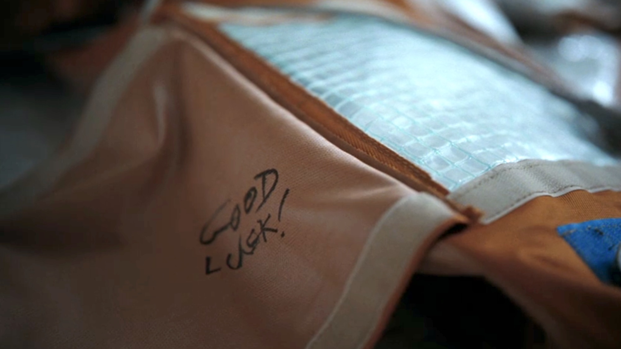The words 'Good luck!' written on the sleeping bag in Project Hail Mary