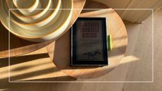 Testing the Hannspree Lumo 7.8 Reader Tablet, showing it in the sunlight on a wooden table