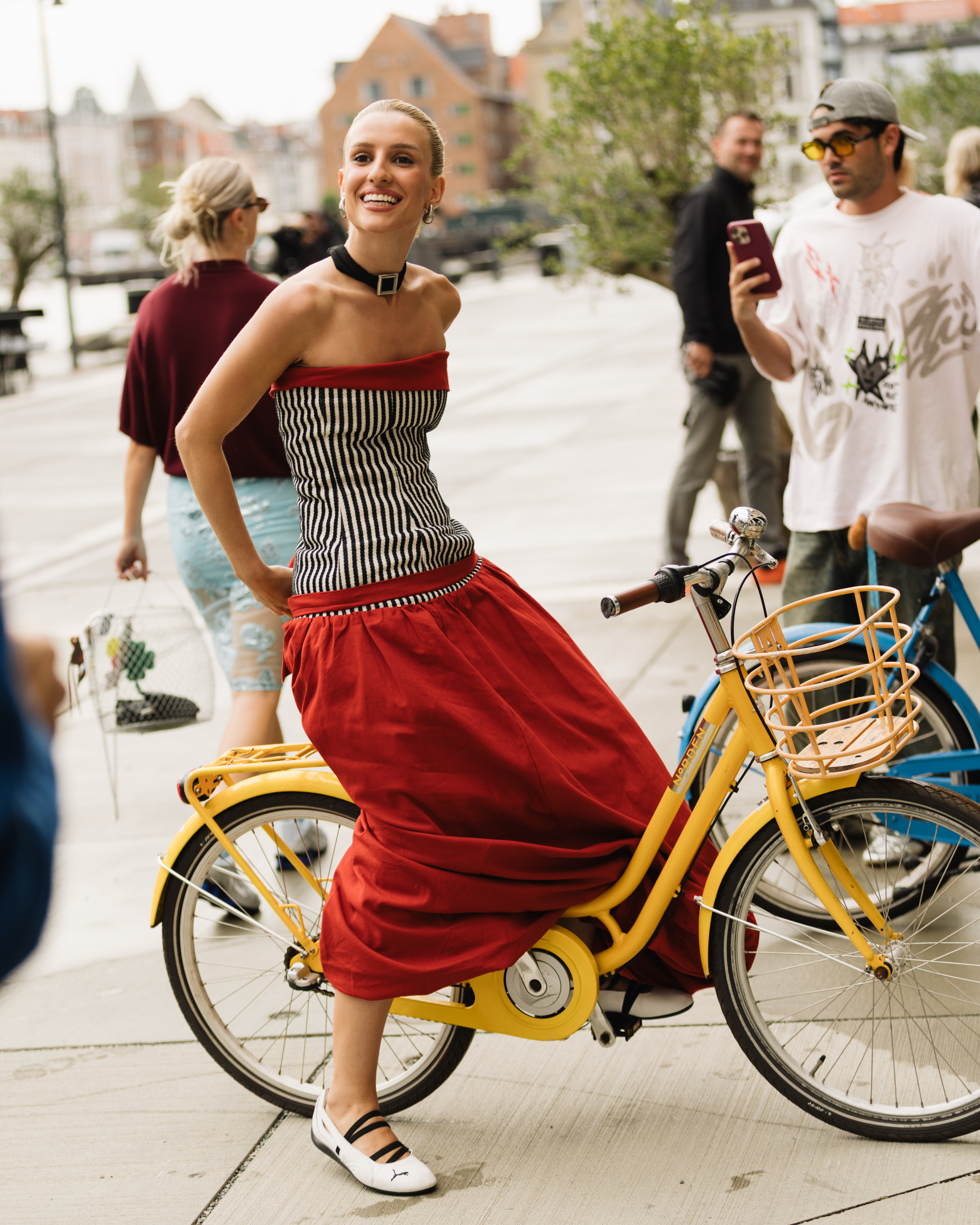 a model wearing a drop waist dress with Puma sneakers at Copenhagen Fashion Week