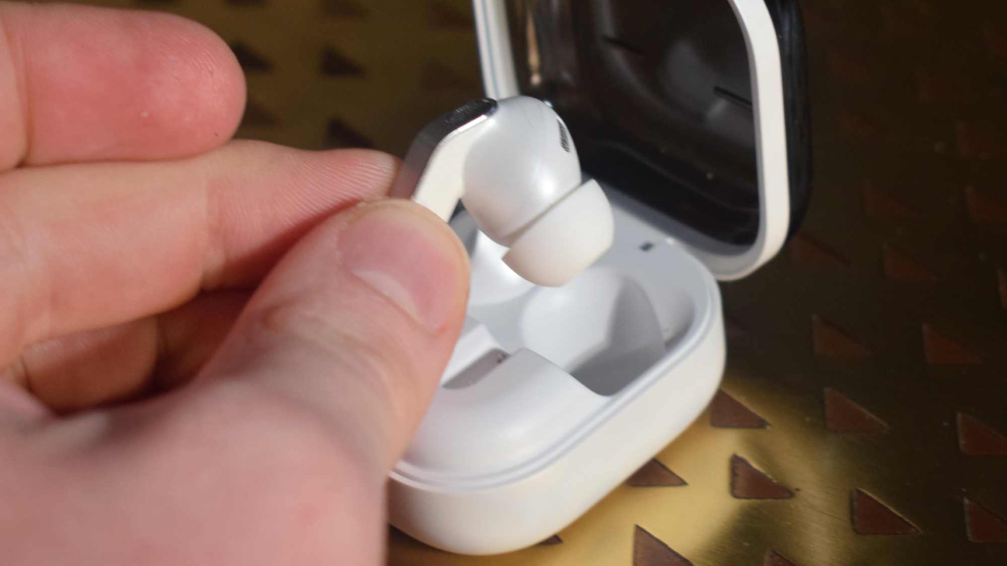 The Samsung Galaxy Buds 4 Pro being placed in a case.