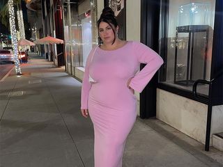 gia wears pink dress on sidewalk at night