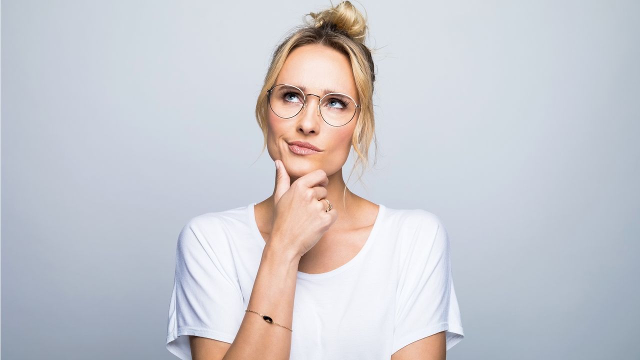 A woman appears to be thinking as she looks into the distance.