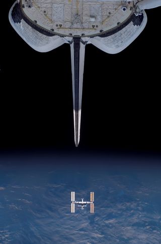 Backdropped by Earth's horizon and the blackness of space, the International Space Station appears to be very small as the Space Shuttle Endeavour departs from the station. Endeavour's vertical stabilizer and orbital maneuvering system (OMS) pods are seen