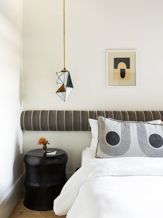 A bedroom headboard with bolster cushion