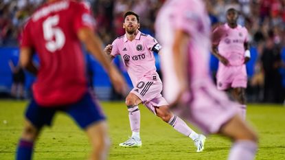 Inter Miami player Lionel Messi mid-stride in the iconic baby pink kit