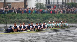 The Oxford and Cambridge teams under Barnes Bridge in the Boat Race.