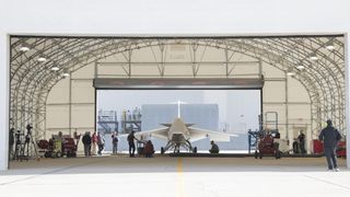 a white jet sits in a hangar in the desert