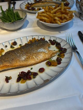 A grilled fish with veggies and frites from Petit Victor Hugo in Paris.