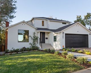 white modern home exterior with front lawn