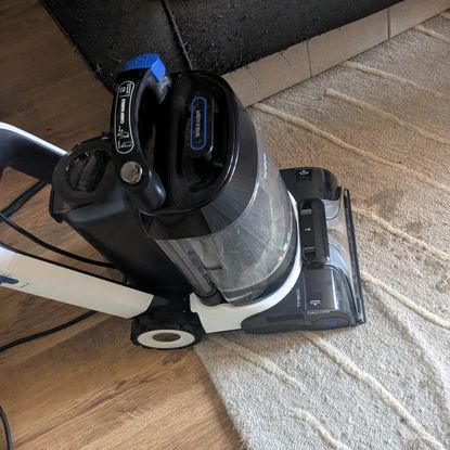 Tineco Carpet One Cruiser being used to clean fresh coffee stain from rug