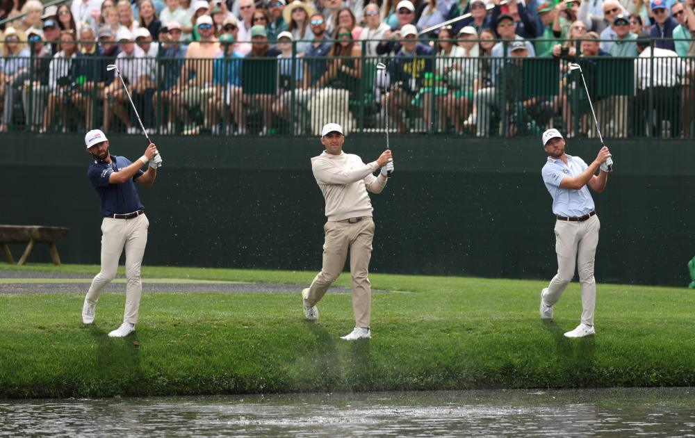 Cameron Young of the United States, Scottie Scheffler of the United States and Sam Burns of the United States skip golf balls across the water
