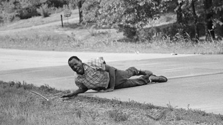 2NCN6G2 Civil rights activist James Meredith grimaces in pain as he pulls himself across Highway 51 after being shot in Hernando, Miss., June 6, 1966. Meredith, who defied segregation to enroll at the University of Mississippi in 1962 completed the march from Memphis, Tenn., to Jackson, Miss., after treatment of his wounds. (AP Photo/Jack Thornell)
