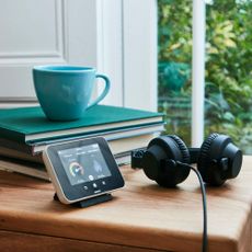 wooden table with smart meter and headphones