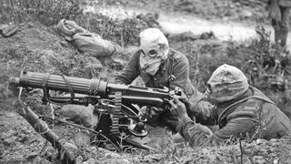 Image of soldiers in gas masks manning a machine gun