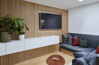 large living room wall with slatted wooden paneling