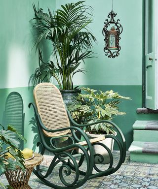 tiled terrace painted green with plants and rocking chair