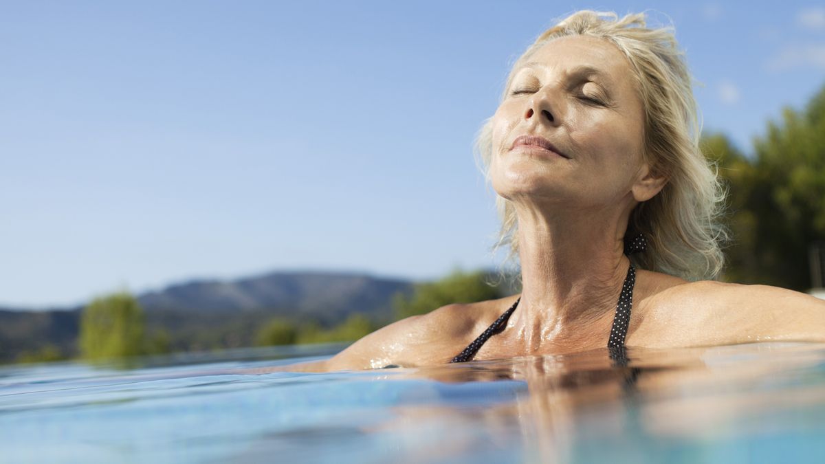 A woman relaxes in warm water during a hydrotherapy session