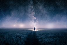 a man looking up at night sky