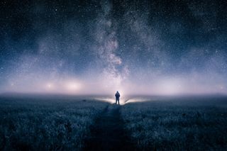 a man looking up at night sky