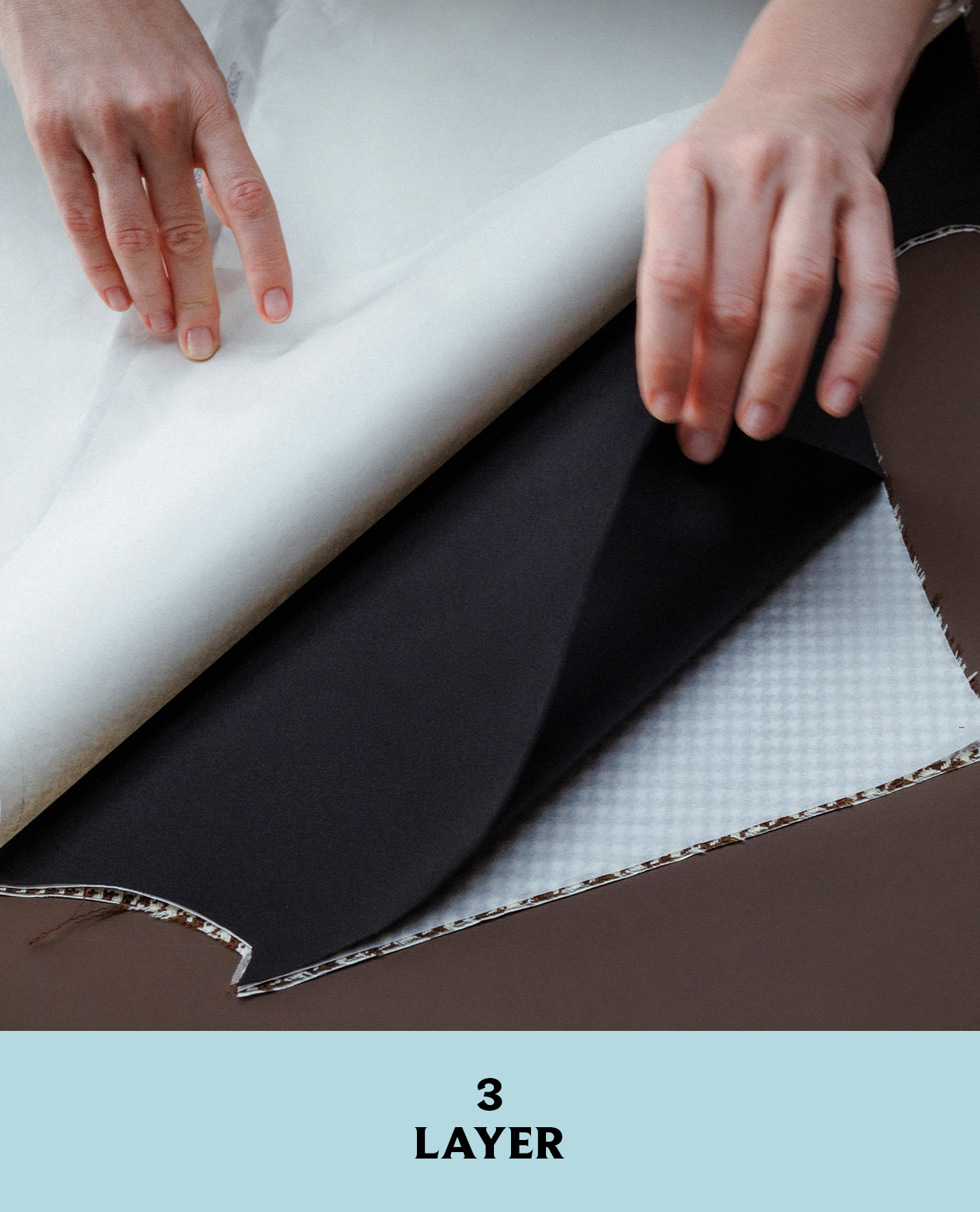 Prada artist touching fabric for the jacket from Look 10 in its fall/winter 2026 collection.