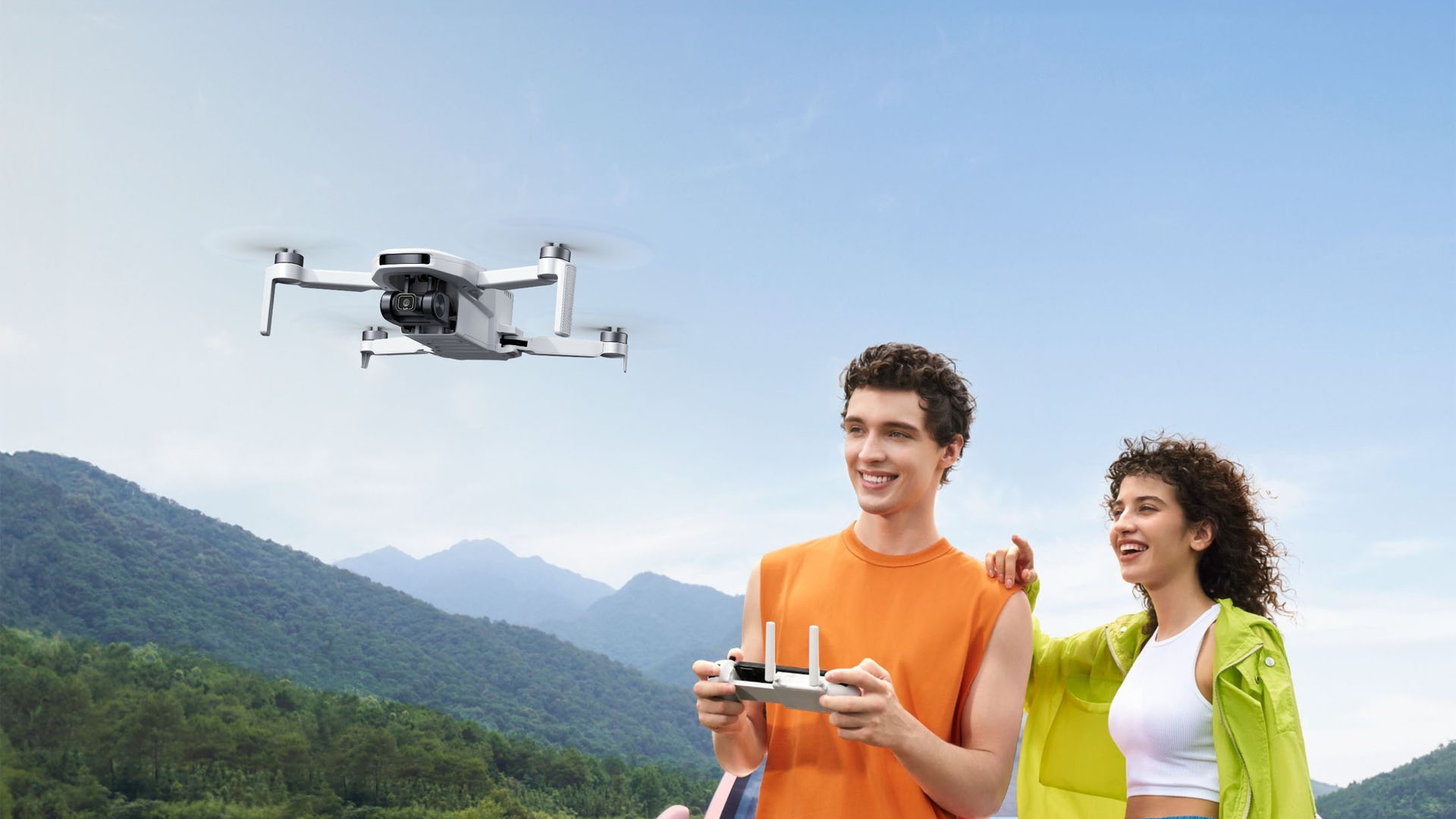 A Potensic Atom LT GPS drone flying near a couple.