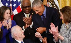President Joe Biden fist bumps former President Barack Obama after Biden signed an executive order aimed at strengthening the Affordable Care Act with Nancy Pelosi by their side