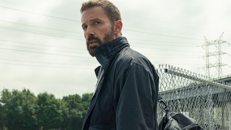 Mark Kimball (Ben Affleck) looks over his shoulder while carrying the ransom money in Animals.