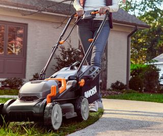 A Worx WG779 mower cutting grass