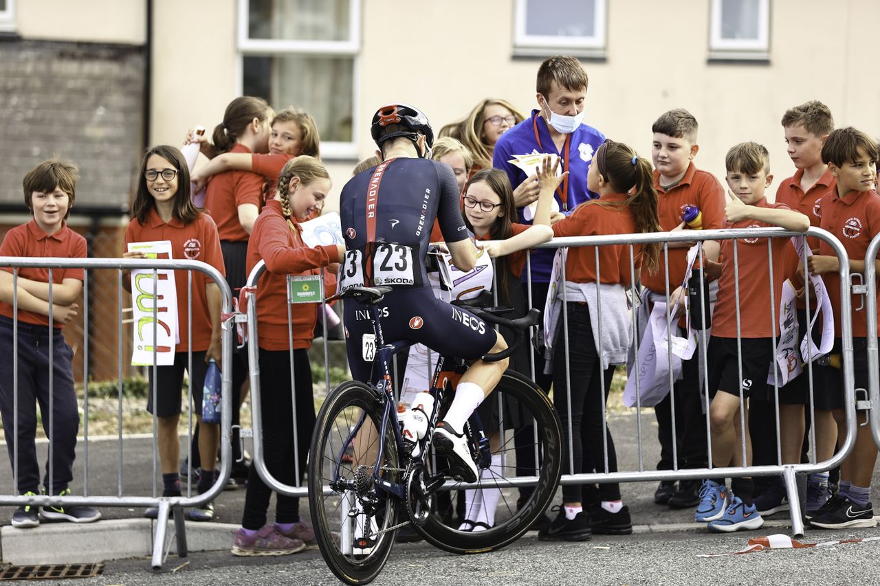 Picture by SWpix.com - 08/09/2021 - Cycling - AJ Bell Tour of Britain Stage 4 - Aberaeron to Great Orme, Llandudno, England - INEOS Grenadier's Owain Doull signs autographs for some school children.