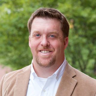 A headshot of Joshua Eyler.